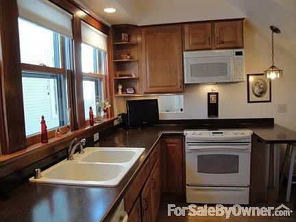 Kitchen
						:
						Refrigerator on wall to left. Island rt of stove has room for sitting @ stools