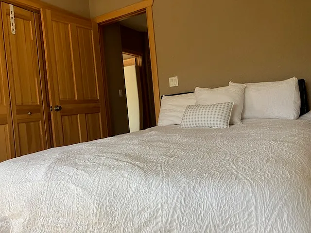 Different angle of queen bed and folding closet