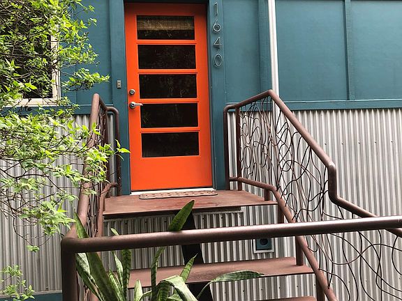 Entrance to home up custom metal staircase