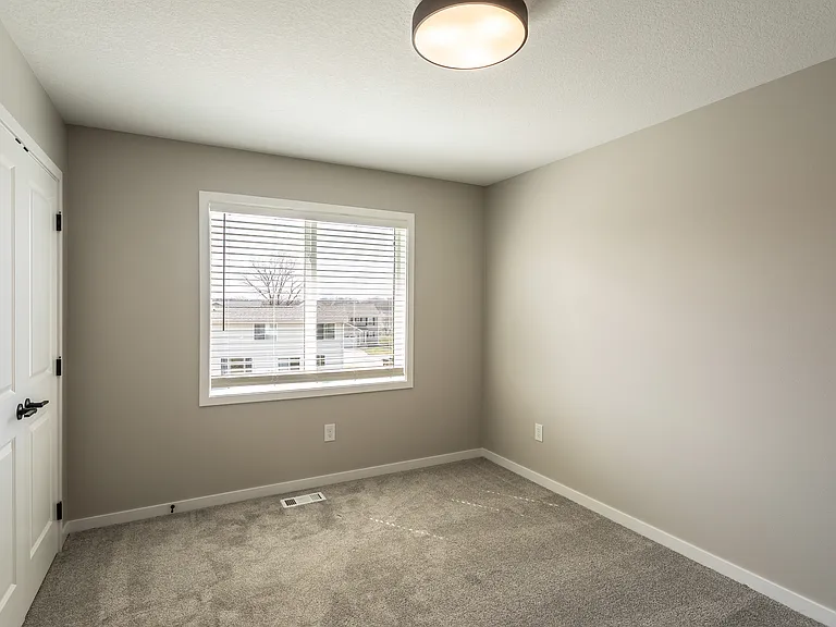 Secondary bedroom with french door closet.
