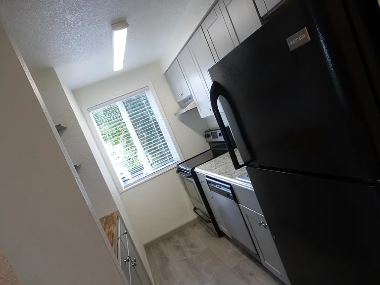 Standing in the laundry area and looking thru the kitchen to the bright window.