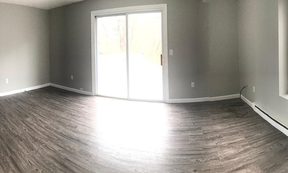 Large living room with private deck out sliding glass doors.
