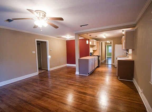 View of living room and galley kitchen.