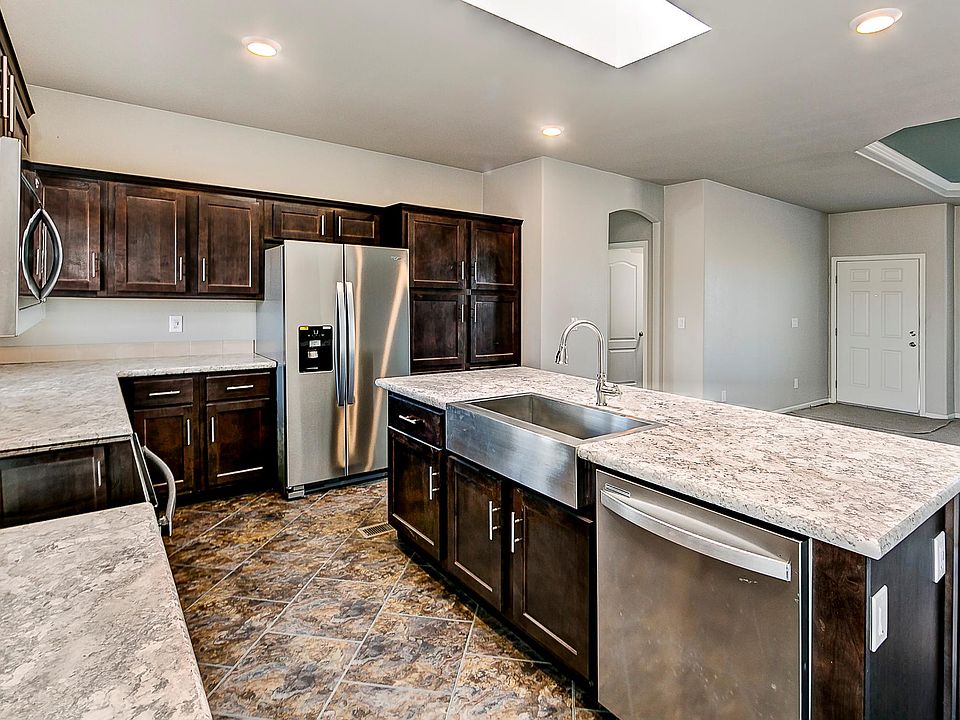 Kitchen & Dining - Solid wood cabinets & upgraded nickel hardware, upgraded stainless appliance package, center island, title back splashes, country farm sink with pull out faucet, skylight, recessed lighting.