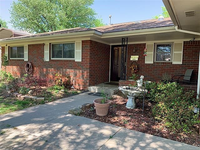 Inviting entry way with covered porch and room for patio furniture - sit outside and listen to the soothing sound of your fountain