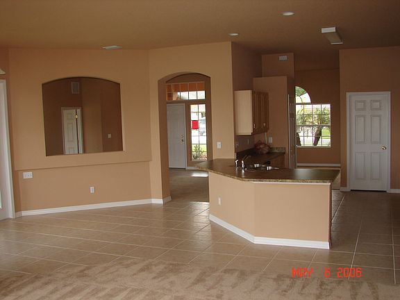 This new big 5 bedroom house has it all.  Located in Watersedge with a new elementary and middle school.  This home is on a cul de sac that was just built this year.  This is the view from the family room looking towards the front of the house.  On the left is the kitchen and door to laundry room and 3 car garage.  To the right is the tiled breakfast area big enough for a 6 top table.  Through the middle doorway and right is the dinning room and through the middle doorway and left is the living room.  You can even see the door to the master if you look through the pass thru to th living room on the right!!!!