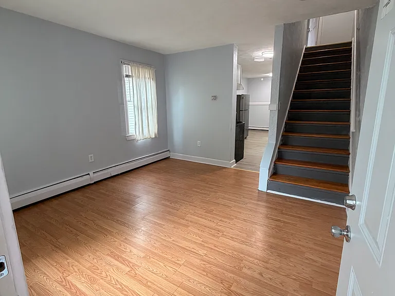 View from the front door, looking into the living room and upstairs.