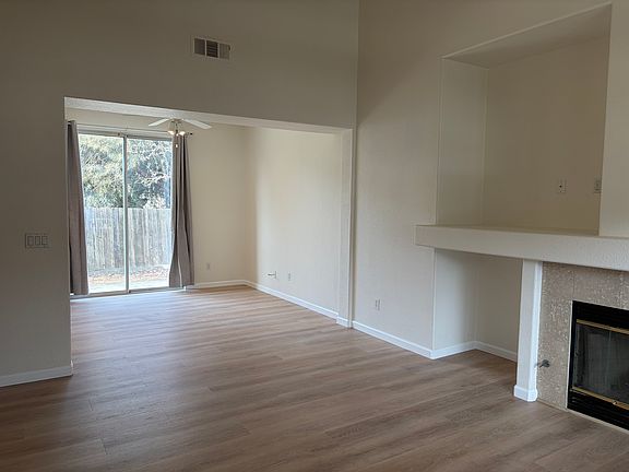 All fresh interior paint and vinyl flooring throughout! This view is from entryway into living area going into dining and kitchen area.