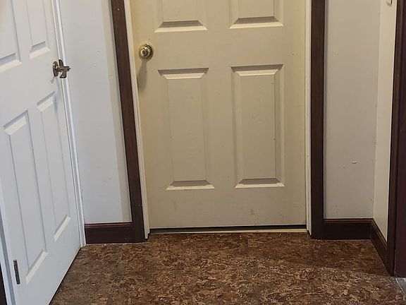 Apartment bedroom door, door to upstairs and opening to laundry/kitchen area