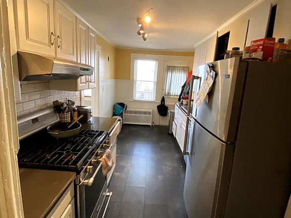 stone counters, full sized fridge with ice maker, and gas stove make this kitchen a cook's dream