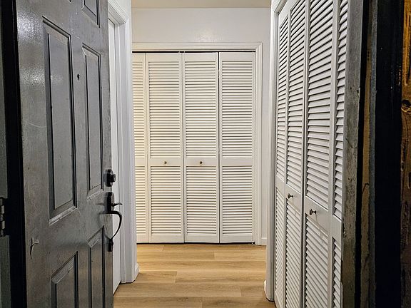 View entering the front door. Washer/dryer closet is straight ahead. Immediately on the right is a closet with lots of storage. 1st bedroom and bathroom are on the left.