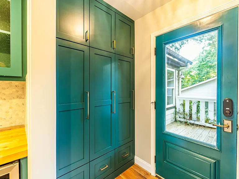 Floor to ceiling custom cabinets and cubbies at the rear entrance.