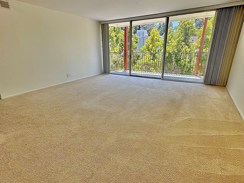 Unit #306 living room with gorgeous views of the trees of San Mateo Park!