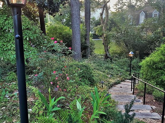 front entry stone staircase with gas lanterns