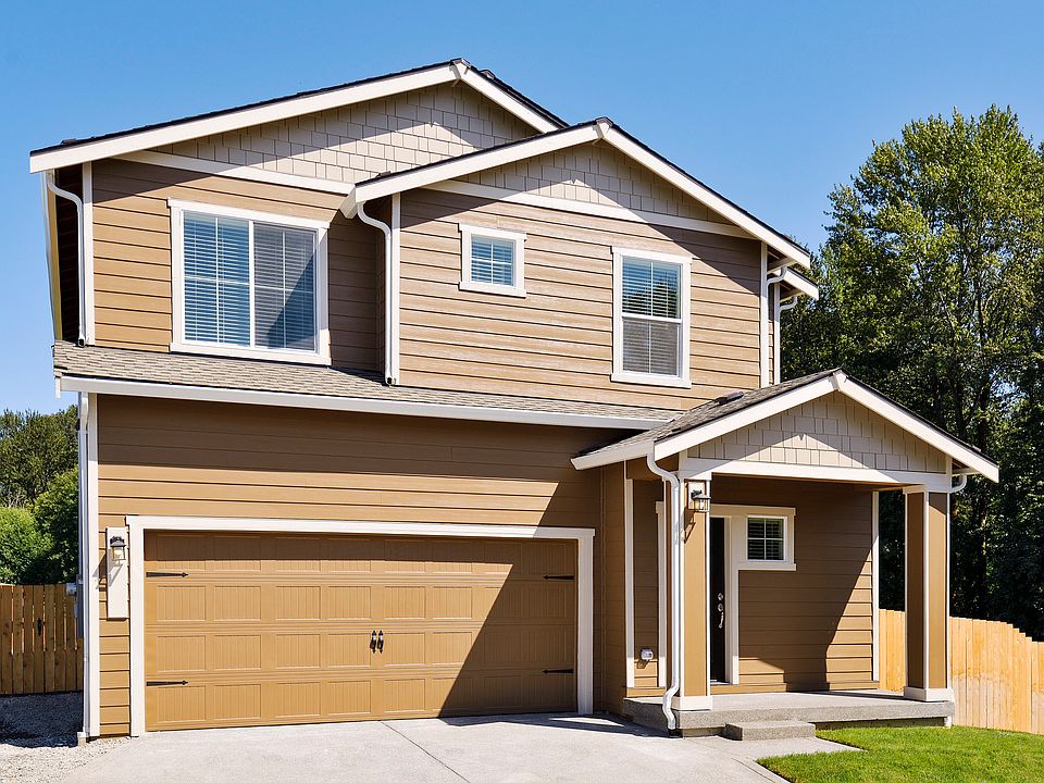 Beautiful two story home at Connell Park with siding and stone and front yard landscaping