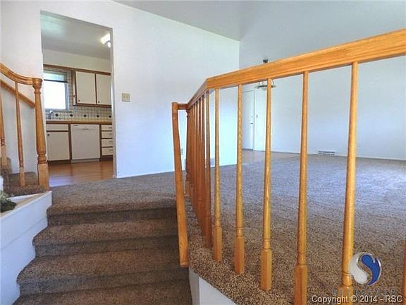 The entry features ceramic tile and leads up to the main level w