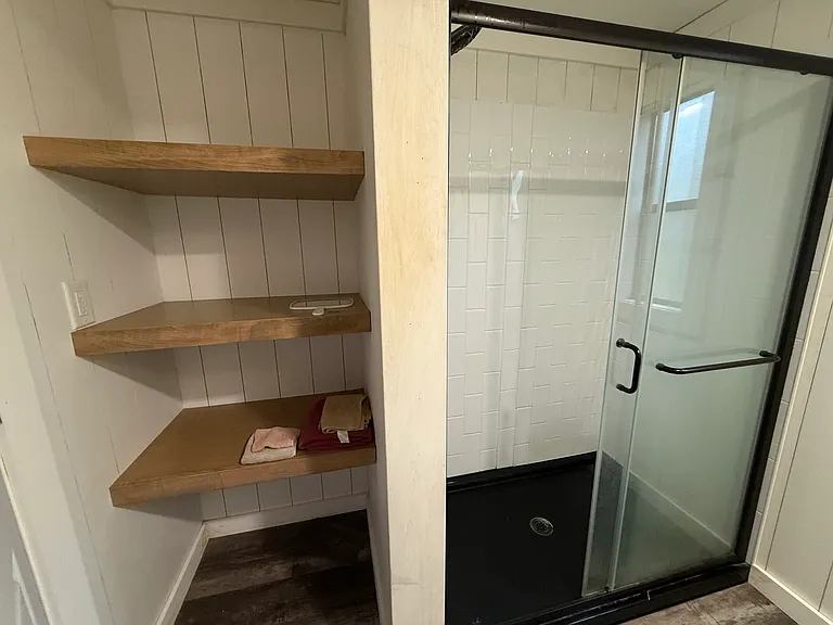 Master bath shower and linen shelving