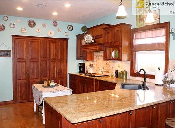 Kitchen has solid maple wood floor, solid cherry wood cabinets, granite countertop.