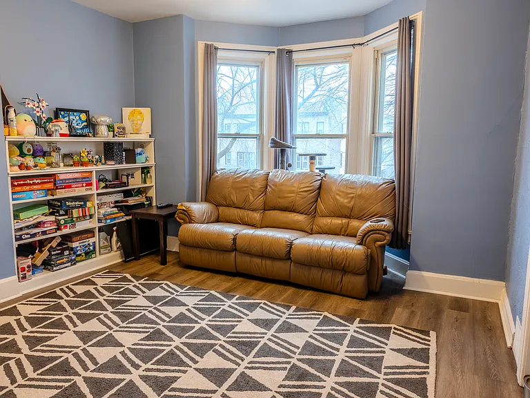 Living room boasting large windows and abundant natural light.