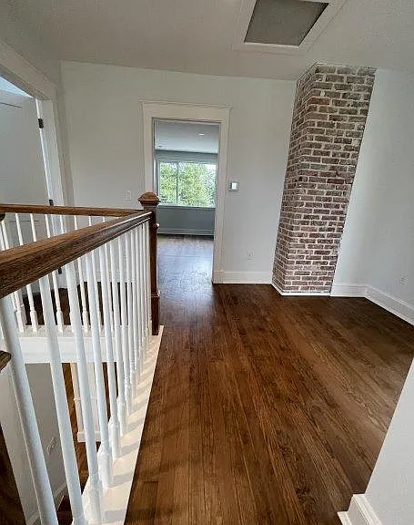 Second floor landing with exposed brick.