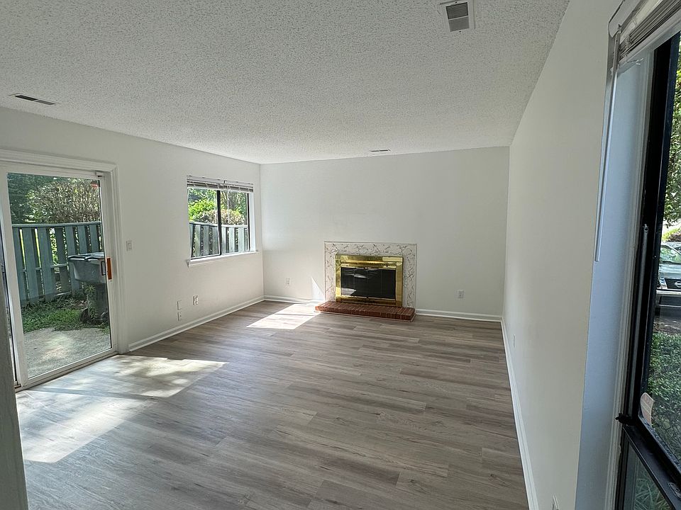 Large den with fireplace. Sliding glass door to outside privacy fenced patio.