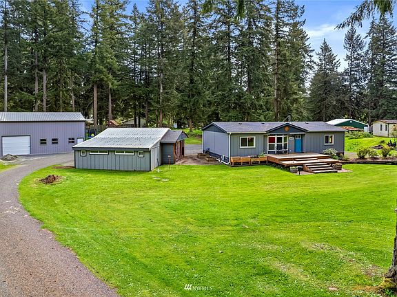 Shop, additional two car garage with smaller workshop in back of it.   Circular drive way, two RV hook ups - one full in back and another one in new shop.  1.26 acres allows you to stretch out and enjoy the beauty of land.