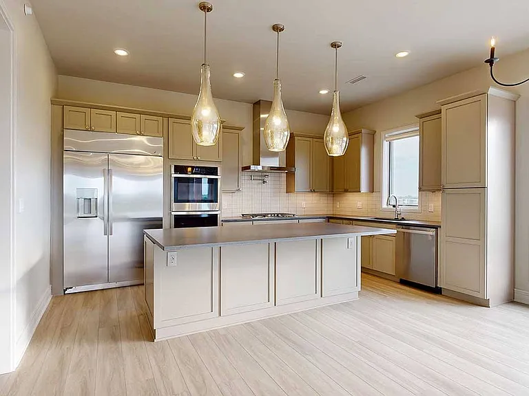 Entertain with ease in the Wrangler Penthouse's gourmet kitchen, outfitted with high-end appliances, quartz countertops, and designer lighting.