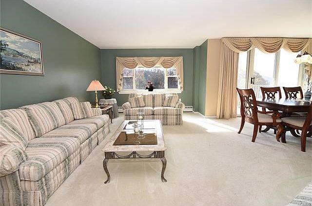 Livingroom showing located next to the dining room with slider to balcony.