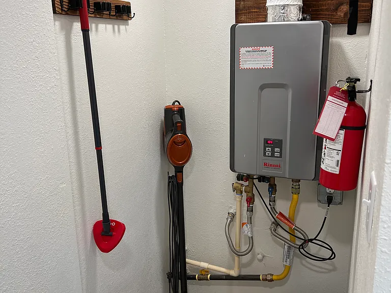 Utility area and gas powered on demand water heater. Takes a minute to get to the tap but you will never run out of hot water.
