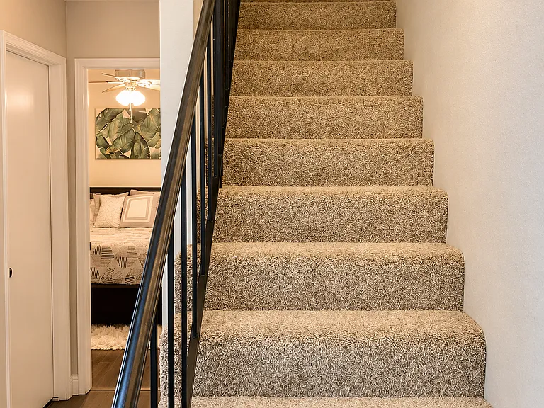 Stairs (washer & dryer underneath the staircase), with both upstairs and downstairs bedrooms in the background.