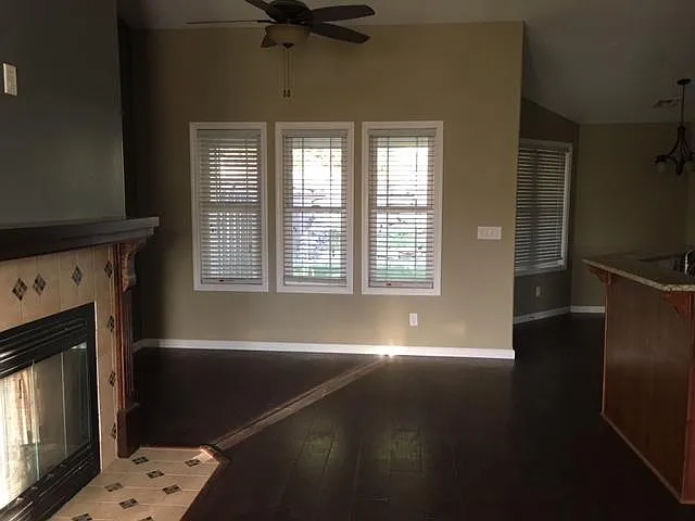 West side of living room. Wood flooring in living room and K