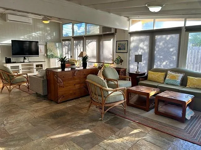 Great Room with Vaulted Ceiling and glass walls to garden