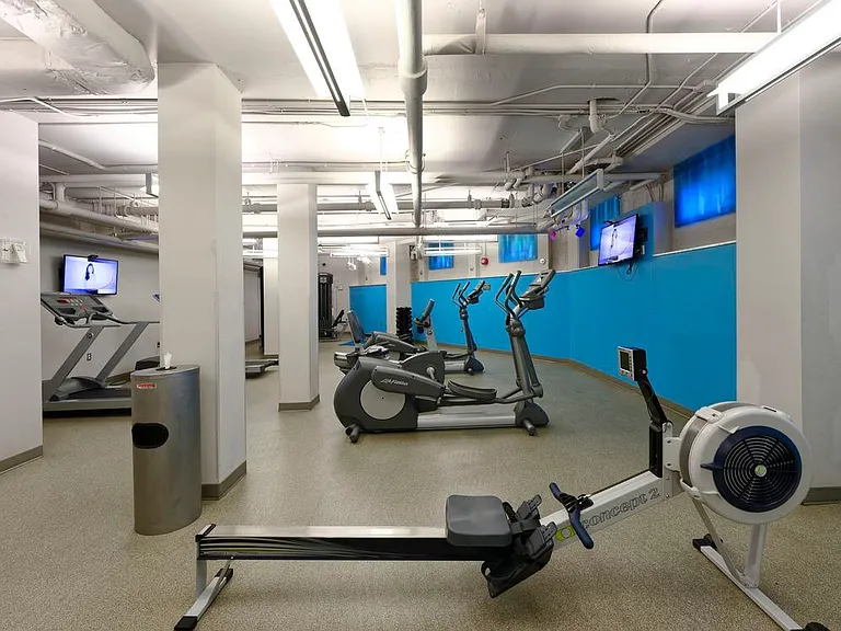 Fitness center with cardio equipment and flat screen televisions