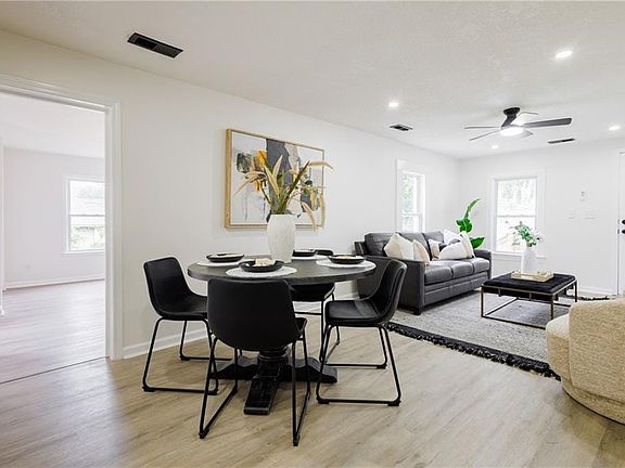 Open-concept living space featuring wood-finish flooring, recessed lighting, and a ceiling fan