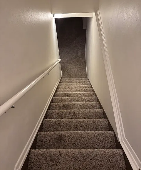 Entrance with staircase leading downstairs.