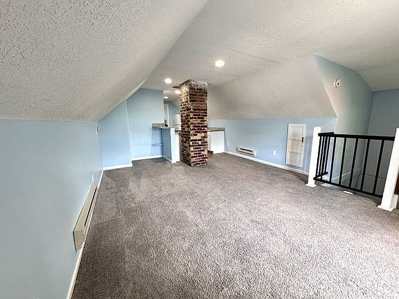 Living room view with a dining nook as well.