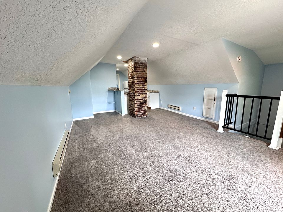 Living room view with a dining nook as well.