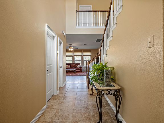 Hallway featuring a high ceiling, coat closet and art niche