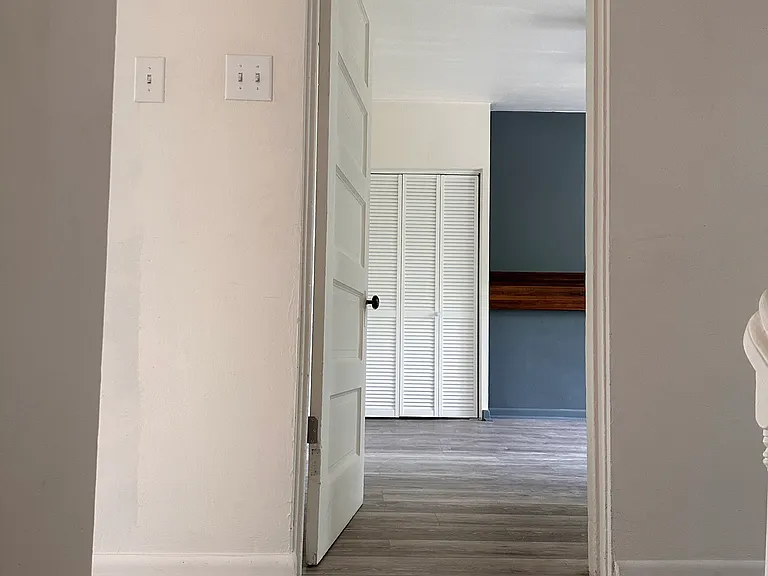 Bedroom 1 with beautiful flooring and large closets