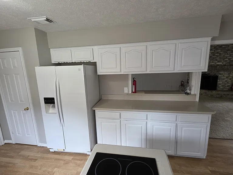 More storage & plenty of counter space with pass through & bar into family room.