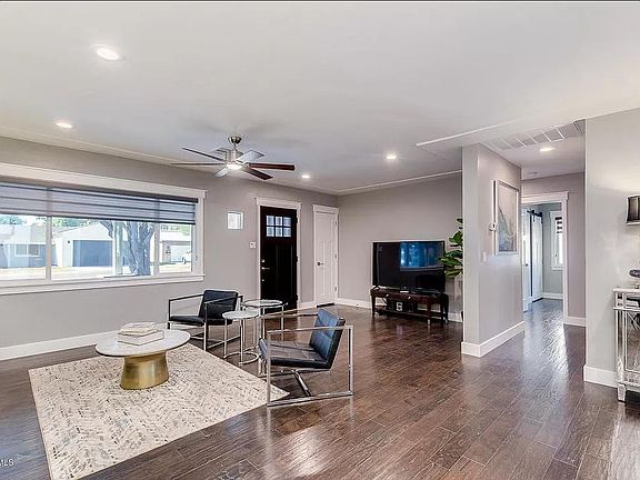 Living Space with open floor plan, dual sheer zebra blinds, hardwood floors , recessed lighting and chrome fixtures