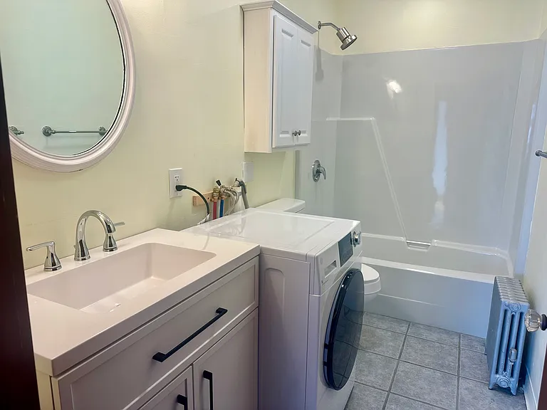 Bathroom with tub and high efficiency steam washer/dryer combo unit (hoses will be boxed in for aesthetics)