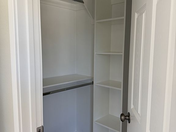 Closet with hangers and shelves.