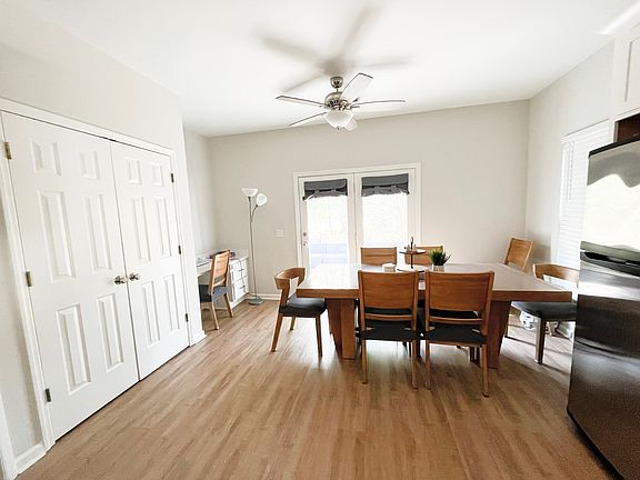 from kitchen into eating area. New flooring, large pantry closet, eat in kitchen with small desk and doors to outside patio.