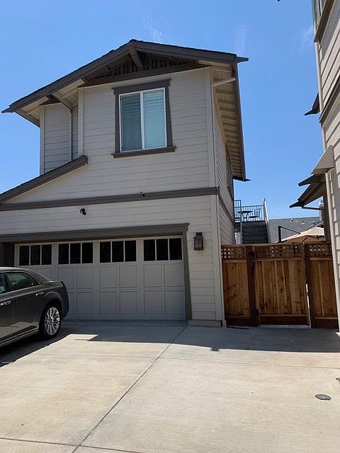 Apartment is upstairs of a detached garage in back of property. Foreground drive-way is for off-street parking