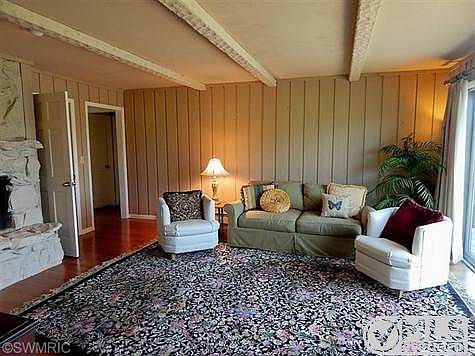 LIVING ROOM WITH FIREPLACE AND WOOD CEILING BEAMS