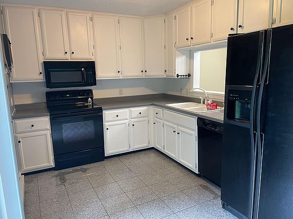 Kitchen with granite floors, lots of storage and dishwasher.