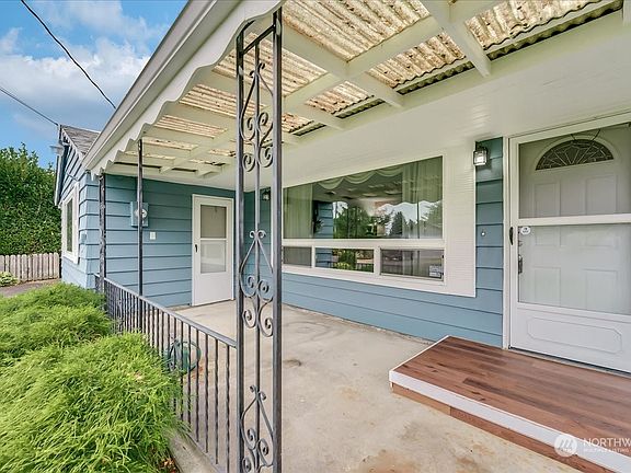 A large covered porch shelters guests and packages, and provides an extra space to enjoy some fresh air.>