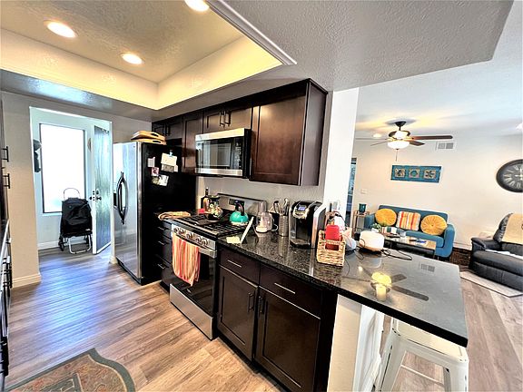 Kitchen with new cabinets and appliances. Entry door to left of photo.