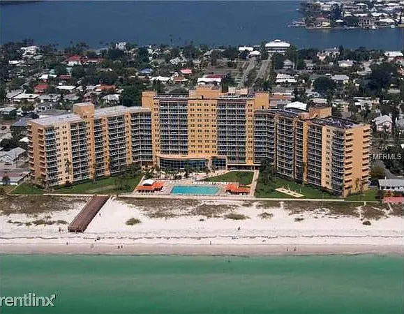 Building with olympic size pool facing the beach.